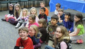 Kids sitting crosslegged at a Kidz Time program @ Northville Disrict Library