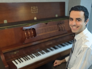 Pianist David Rodgers sitting at his piano.
