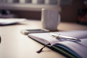 Rise & Write image with book, pen and coffee mug