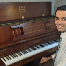 Pianist David Rodgers sitting at his piano.