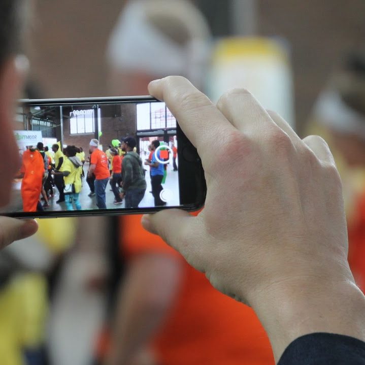 Smartphone using camera to photograph people.